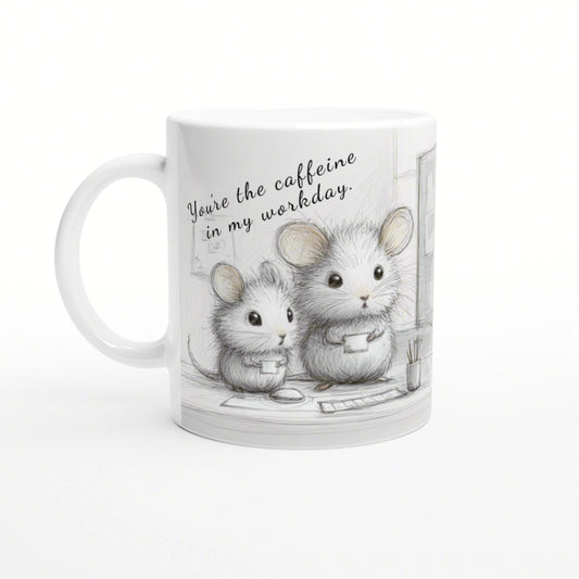 White mug with pencil drawing of two mice at a desk and the caption You're the caffeine in my workday.
